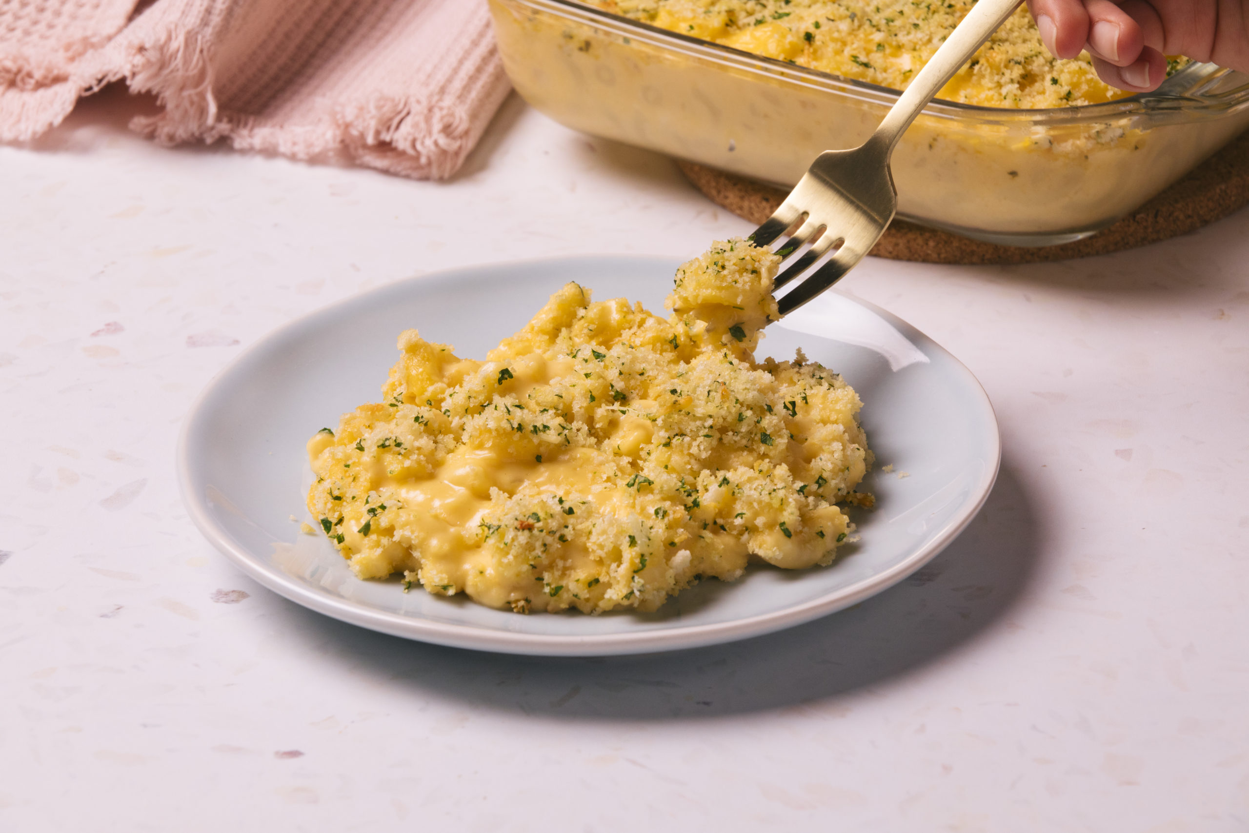 mac and cheese topped with breadcrumbs on a plate.