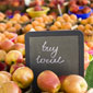 apples at the store with buy local sign