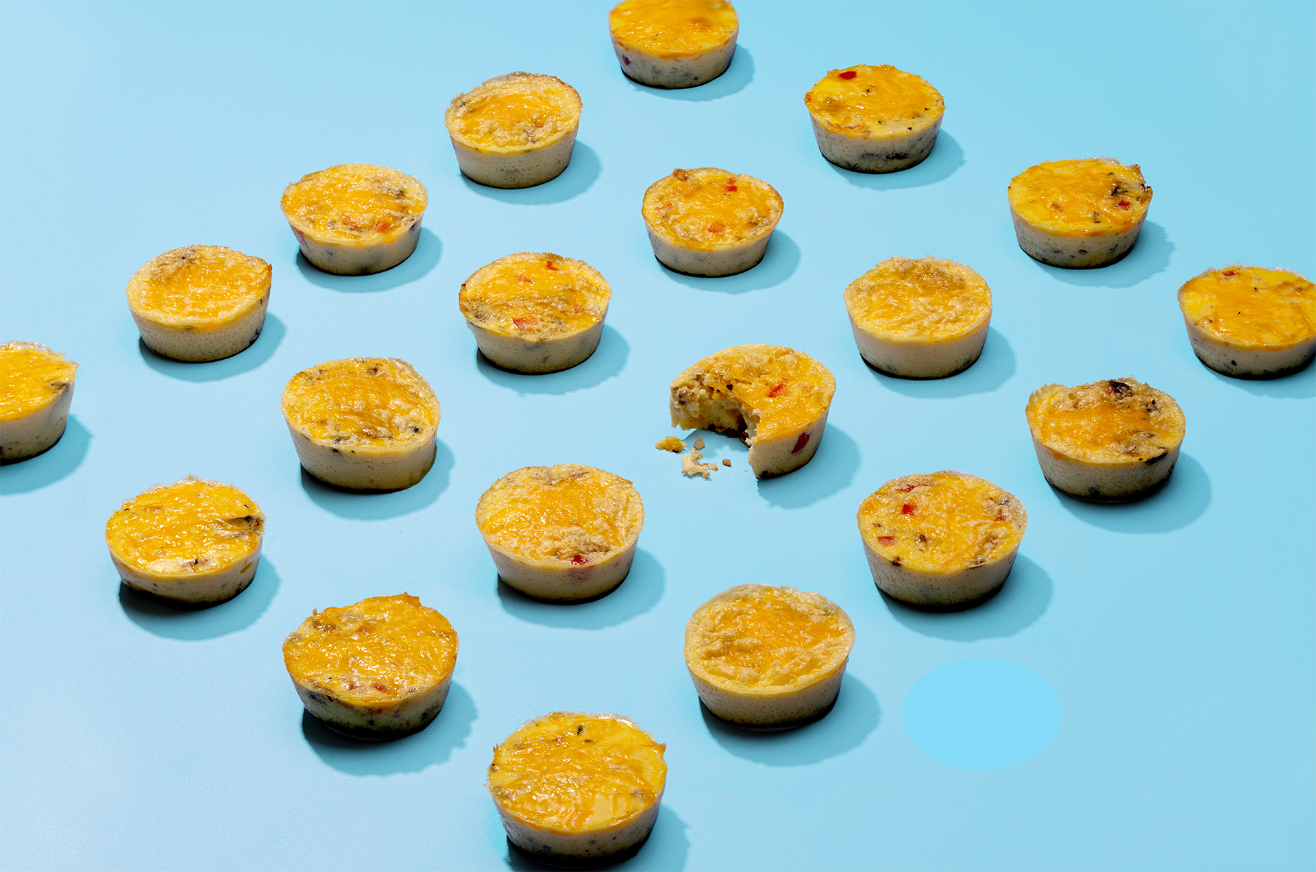 Collage of egg bites with the middle one with a bite missing