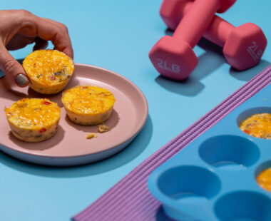 Plate of cottage cheese egg bites near weights and yoga mat