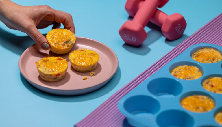 Plate of cottage cheese egg bites near weights and yoga mat