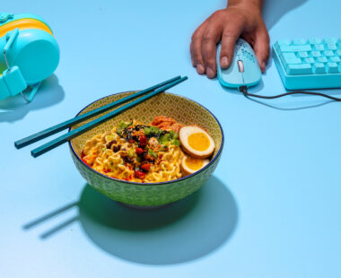 bowl of ramen with keyboard and mouse