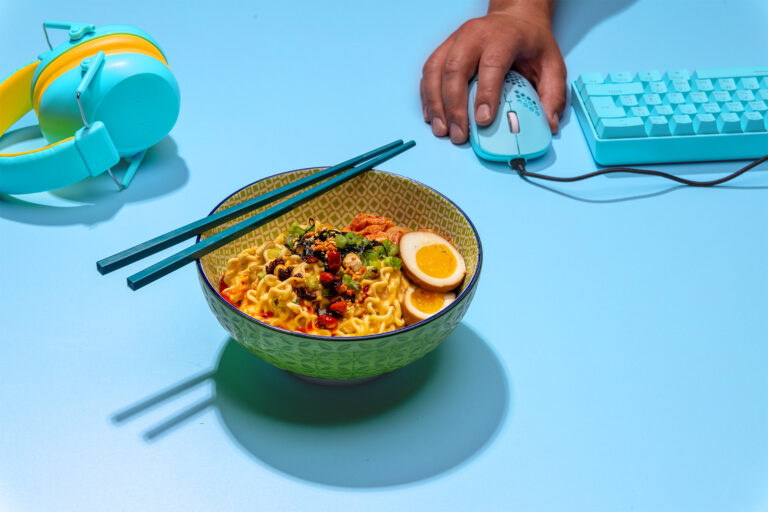 bowl of ramen with keyboard and mouse