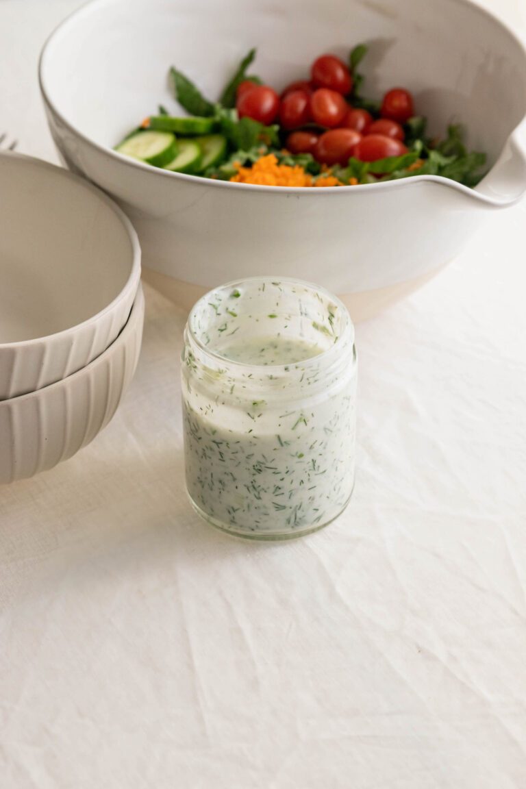 jar of ranch dressing a bowl of vegetables