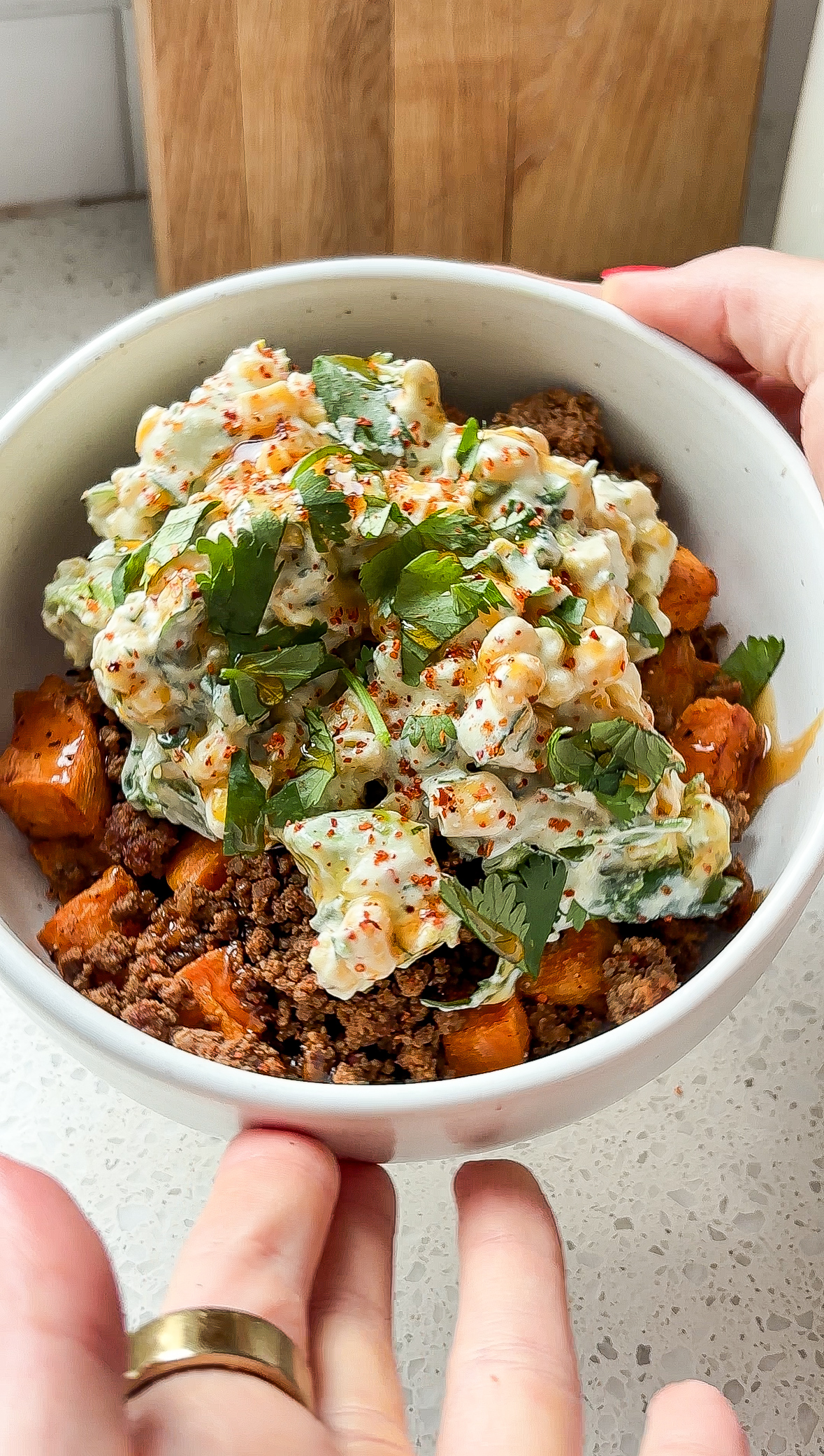 Sweet potato street corn bowl with hands