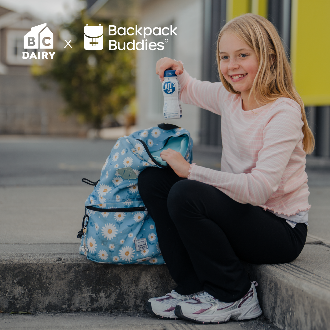 Child on the steps with a backpack and milk